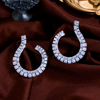 Sculptural Drop Earrings | Designed with a fluid hook shape and brilliant zircon stones
