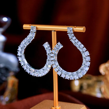 Sculptural Drop Earrings | Designed with a fluid hook shape and brilliant zircon stones