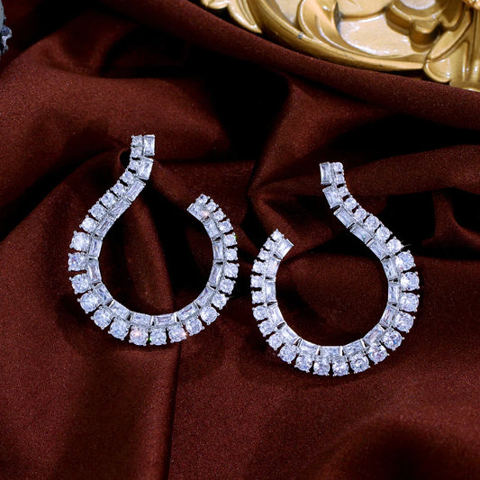 Sculptural Drop Earrings | Designed with a fluid hook shape and brilliant zircon stones