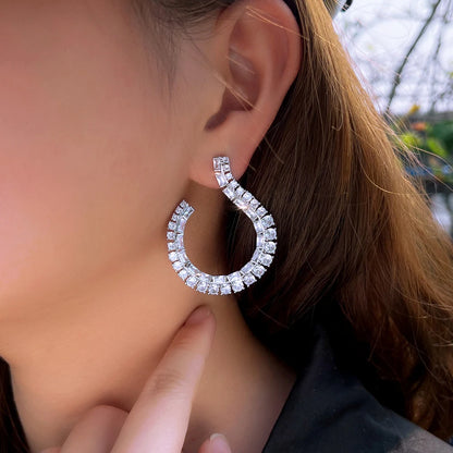 Sculptural Drop Earrings | Designed with a fluid hook shape and brilliant zircon stones